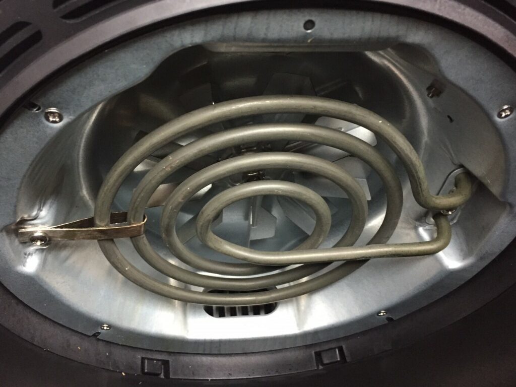 Heating coil inside an open air fryer