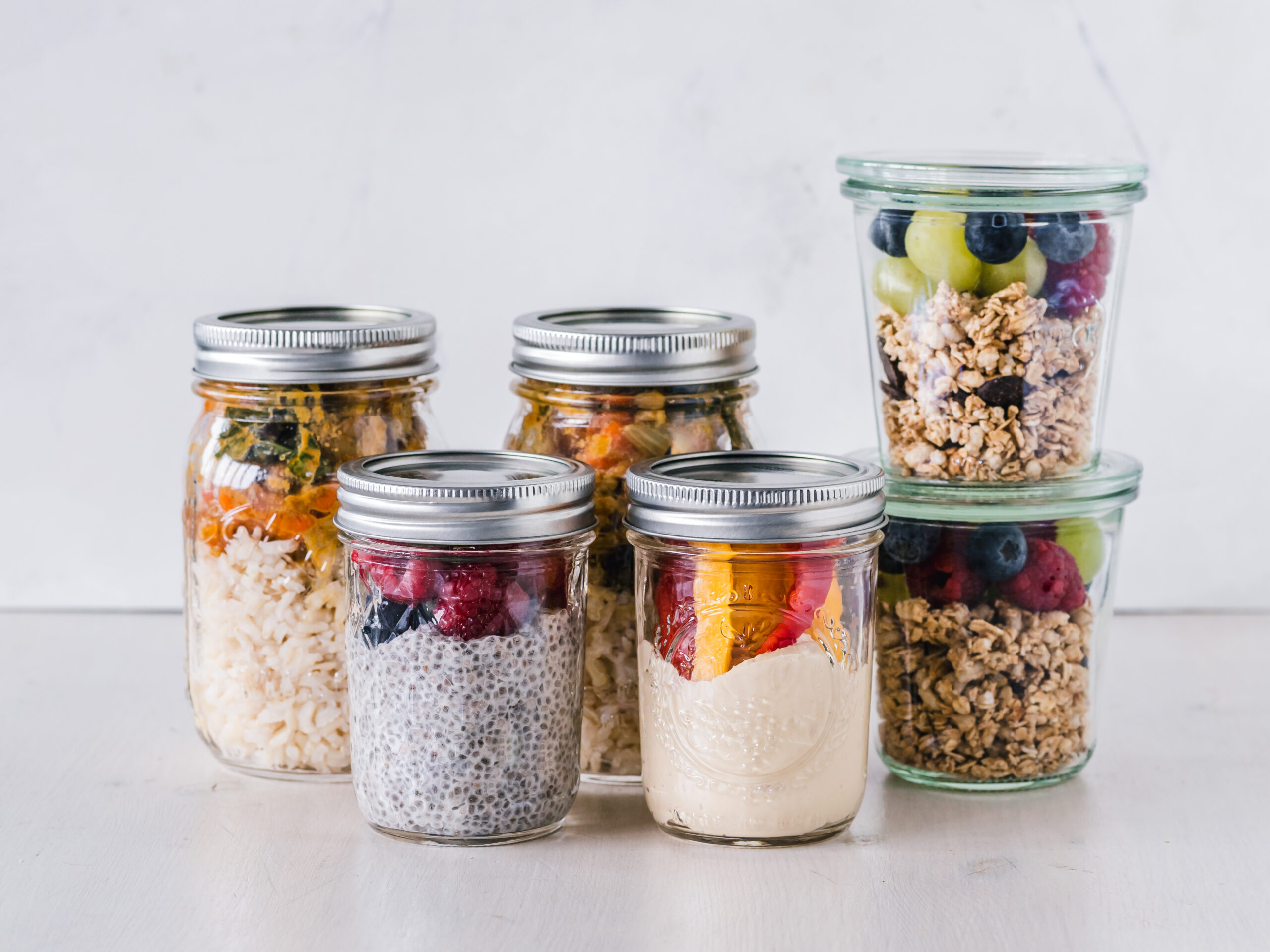 Meal prep containers filled with prepared food and fruit