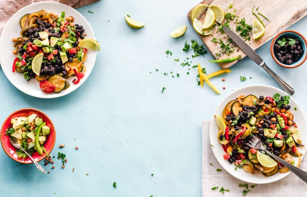 Bowl of rice and beans with vegetables on a table