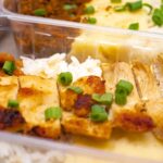 Chicken and rice meal prep container with green onion