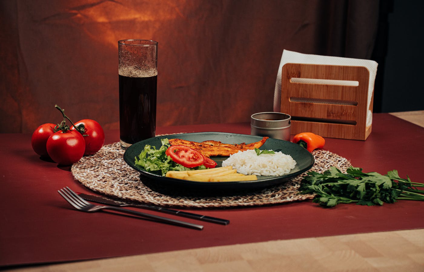 Plate with grilled chicken, white rice, salad, tomatoes, and fries
