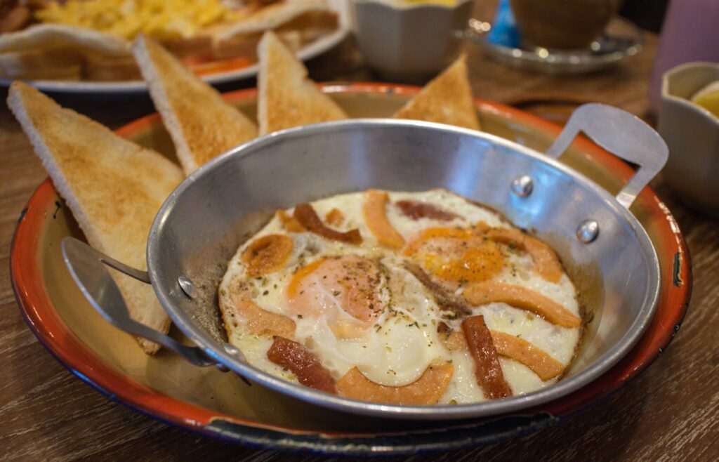 Cooked eggs and toast on a breakfast plate