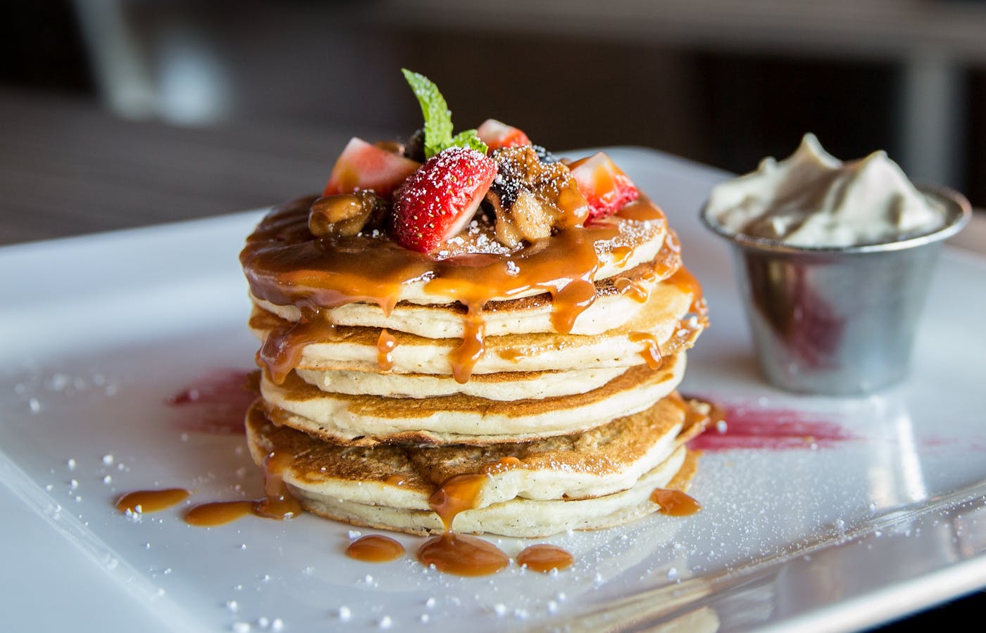 Pancakes with sliced strawberries on a breakfast plate