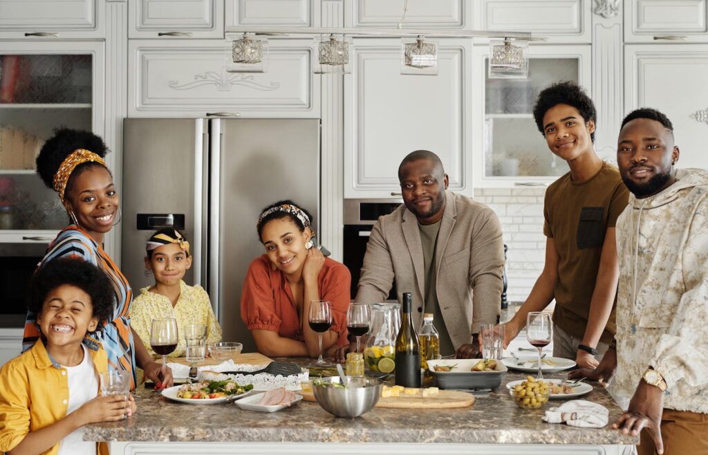 Family standing around a kitchen island with dinner plates