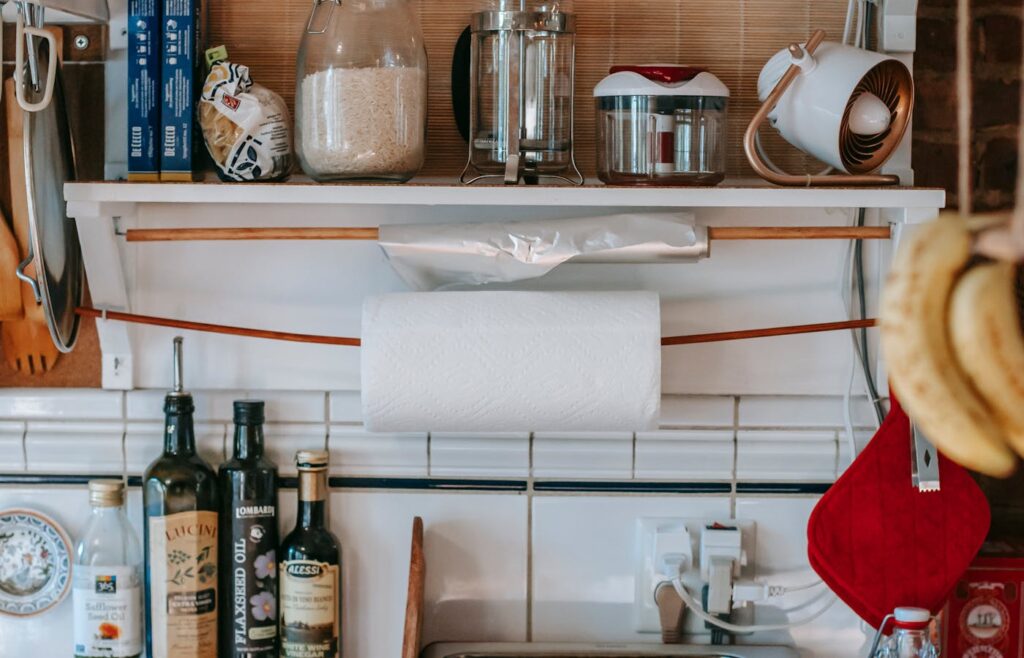 Kitchen shelf with rice, pasta, oils, and paper towels