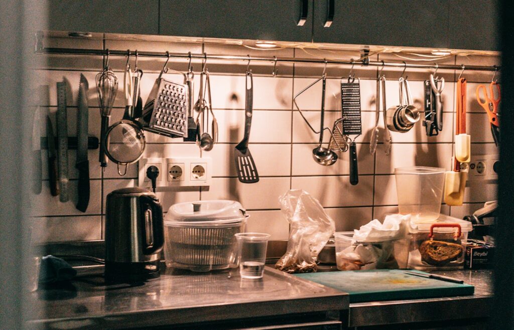 Hanging utensils and knives above a kitchen counter