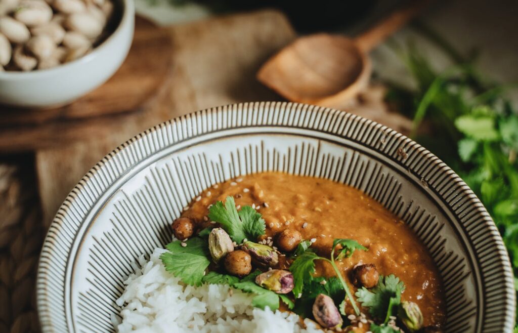Cheap healthy lentil curry served with white rice and fresh herbs