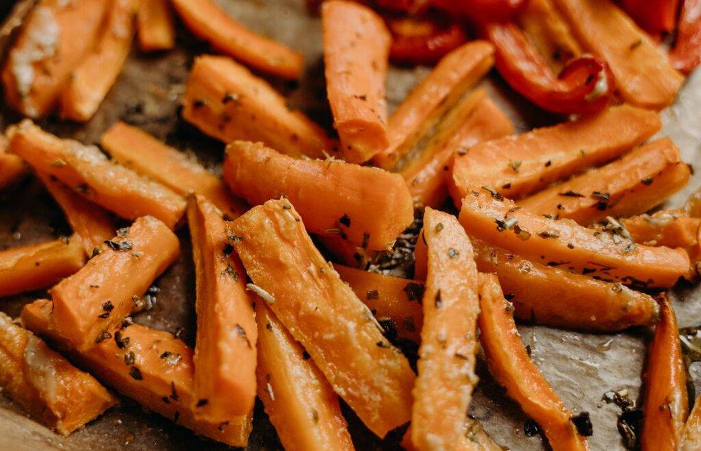 Air fryer carrot vegetable sticks with herbs on parchment paper