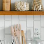 Kitchen shelf with wooden utensils, jars, and dry beans