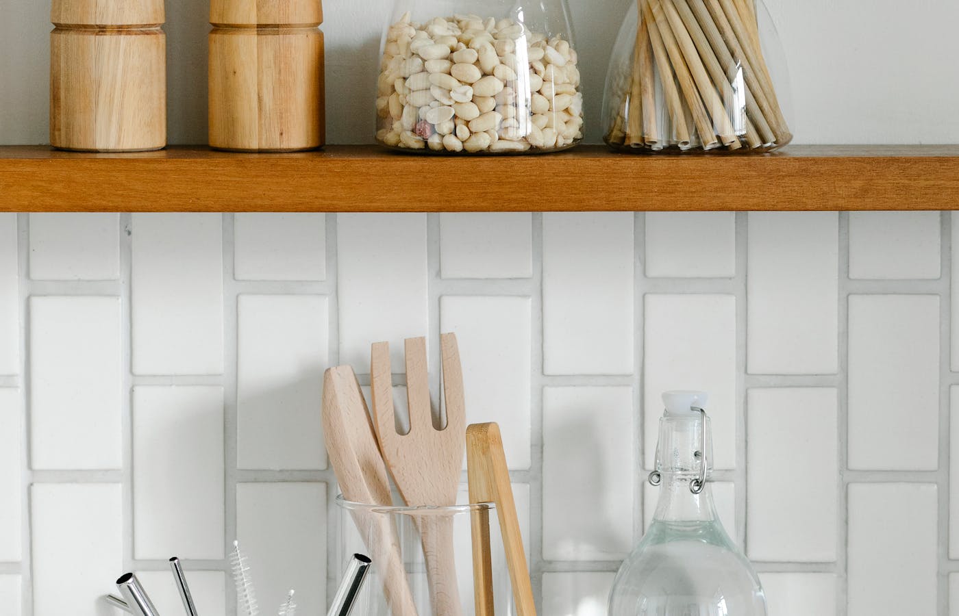 Kitchen shelf with wooden utensils, jars, and dry beans