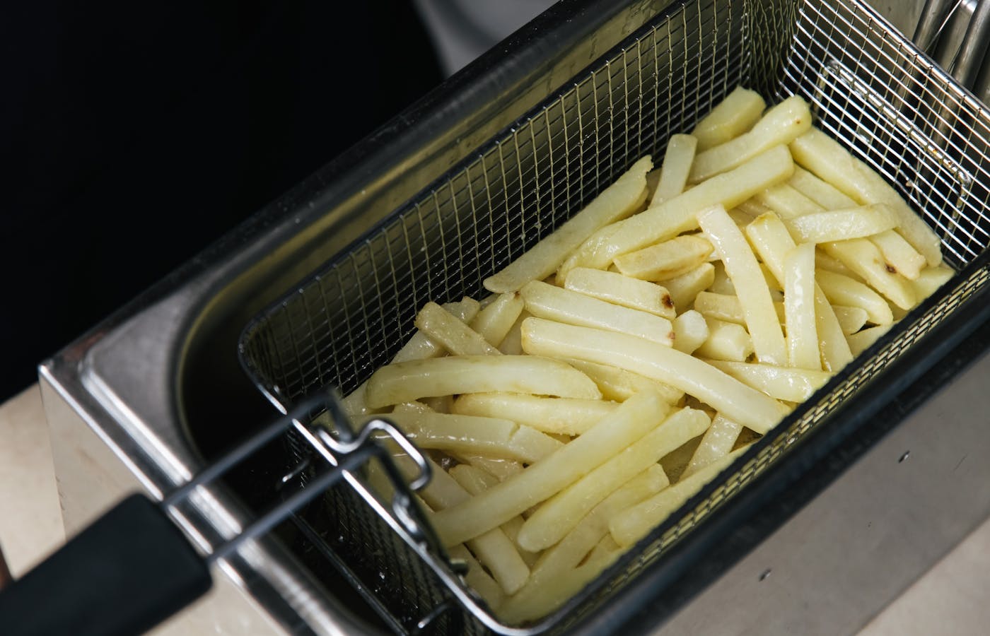 French fries in a metal fryer basket