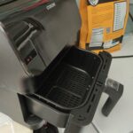 Empty black air fryer basket viewed from above