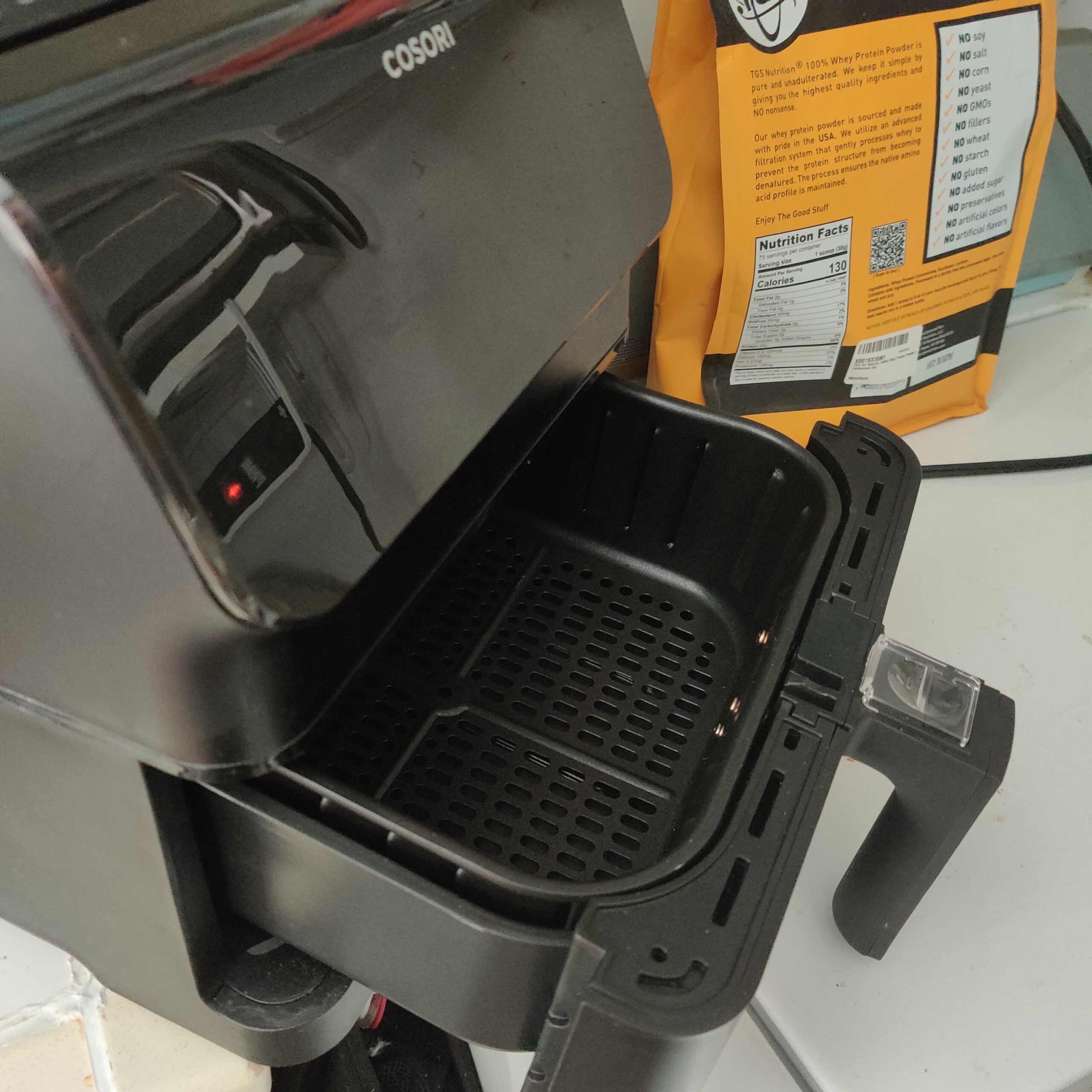 Empty black air fryer basket viewed from above