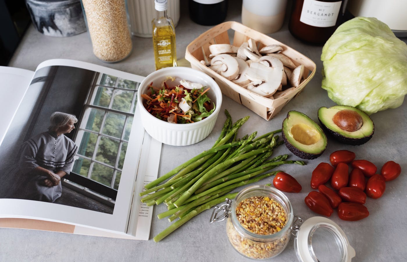 Open cookbook beside fresh ingredients on a kitchen counter
